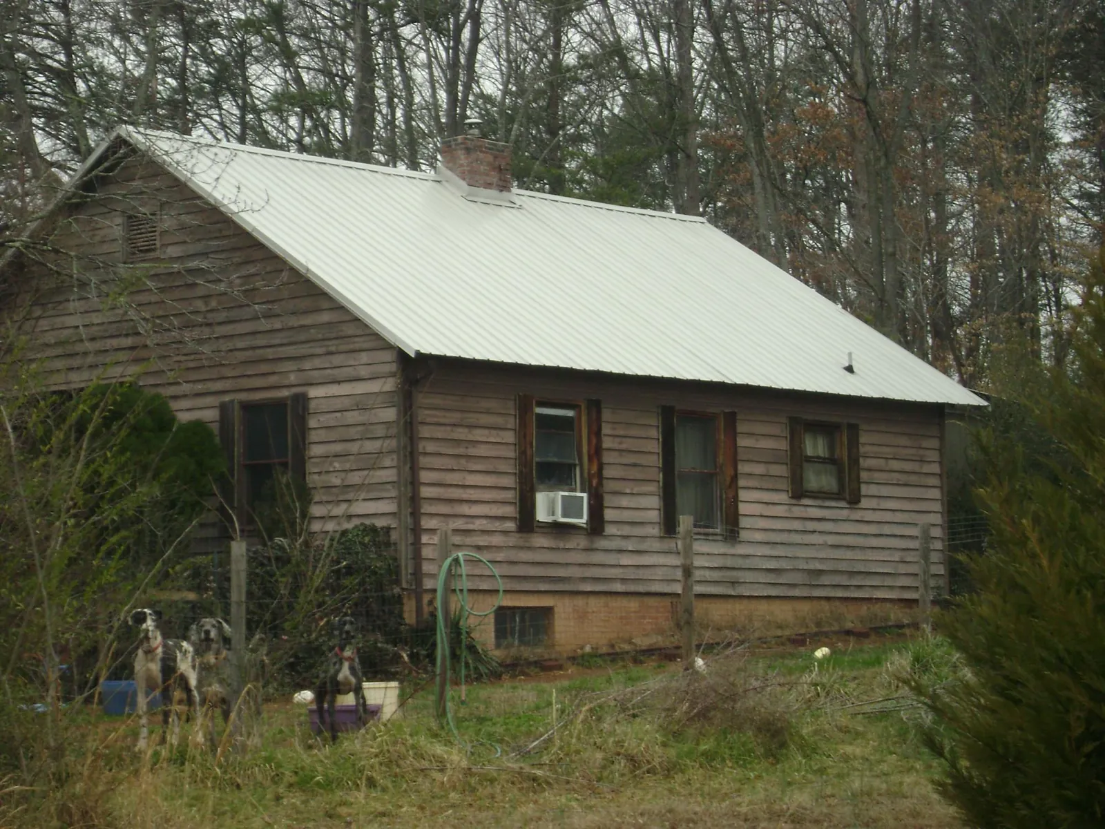 White metal roof on an old wood sided farmhouse, from a Metal Roof Installation job in Descanso